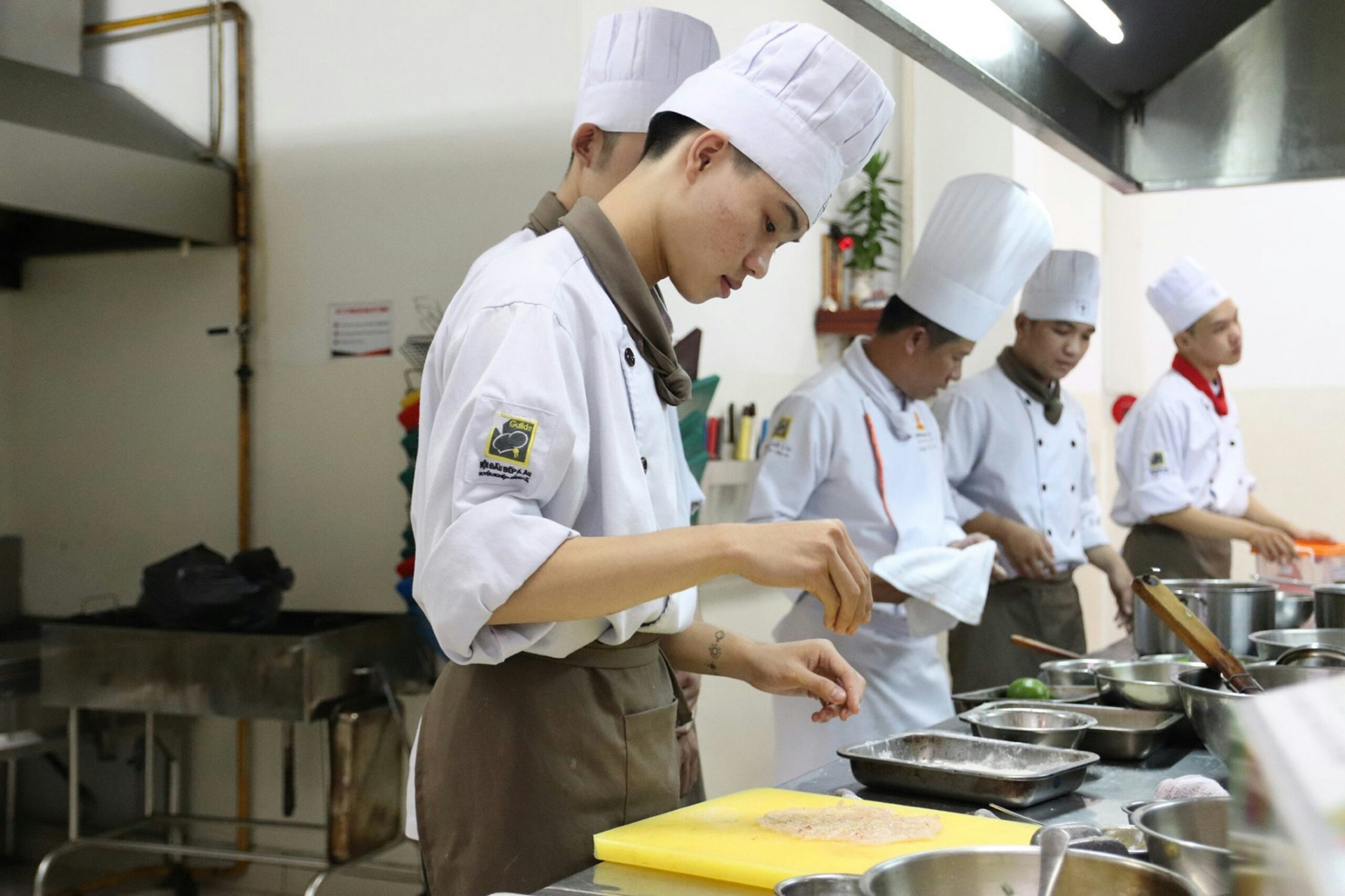 Scout preparing a meal while working toward the Cooking Merit Badge through hands-on cooking experience and food safety practice.